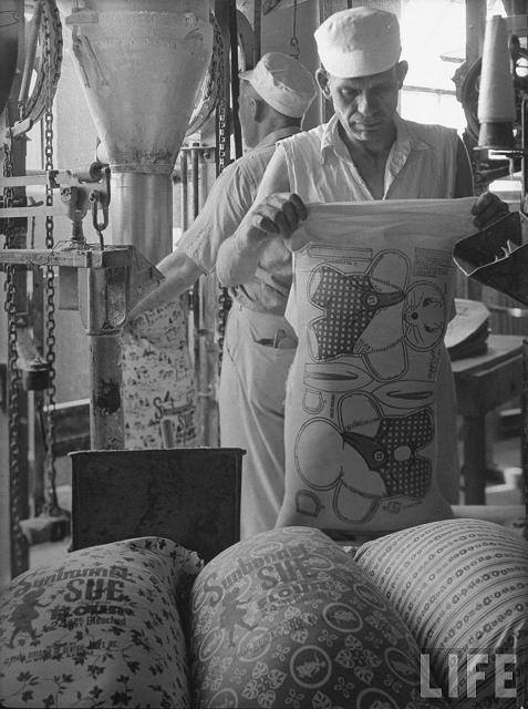 Workers filliing colorfully printed flour sacks which housewives use to make dresses because the labels wash out, at Sunbonnet Sue flour mill.